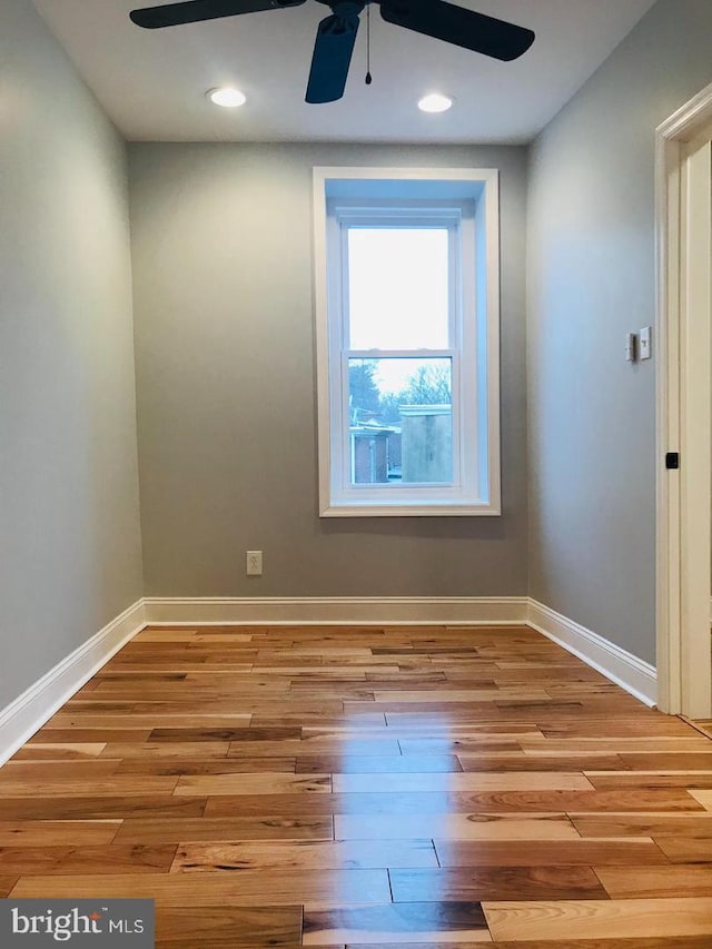 spare room featuring recessed lighting, baseboards, wood finished floors, and a ceiling fan