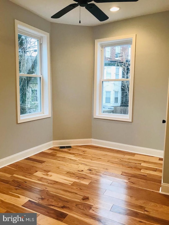 unfurnished room featuring light wood finished floors, visible vents, ceiling fan, baseboards, and recessed lighting