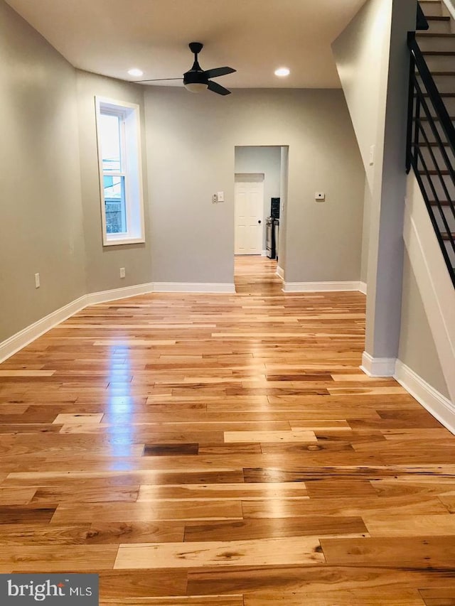 unfurnished living room with recessed lighting, a ceiling fan, baseboards, and light wood finished floors