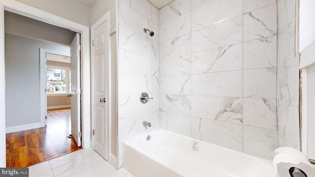 full bathroom featuring bathtub / shower combination, baseboards, and marble finish floor