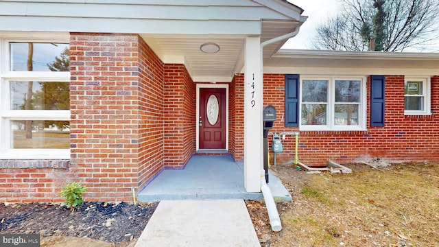 property entrance featuring brick siding