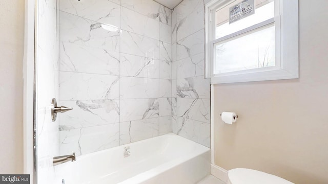 bathroom featuring bathtub / shower combination and toilet