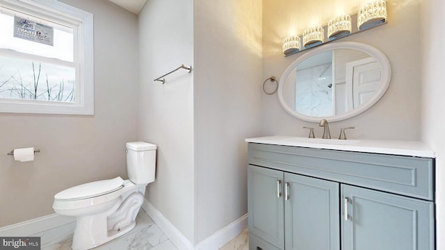 bathroom with baseboards, toilet, marble finish floor, and vanity