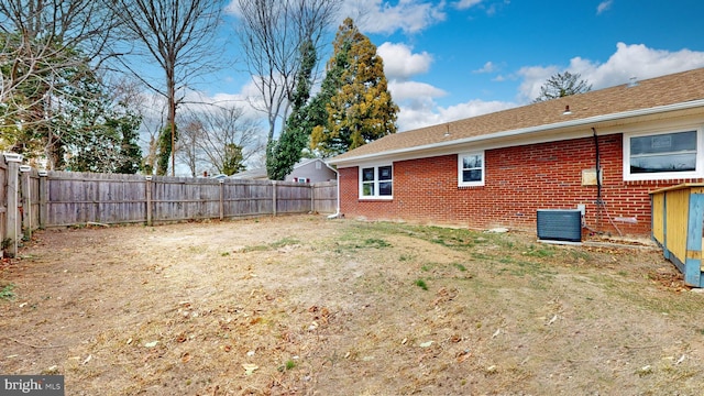 view of yard featuring central air condition unit and a fenced backyard