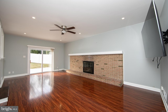 unfurnished living room featuring baseboards, recessed lighting, a fireplace, wood finished floors, and a ceiling fan