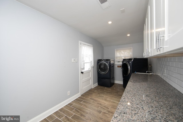 laundry room featuring wood finished floors, baseboards, visible vents, recessed lighting, and washer and clothes dryer