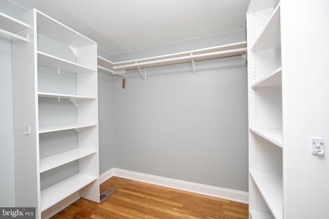 walk in closet featuring visible vents and wood finished floors