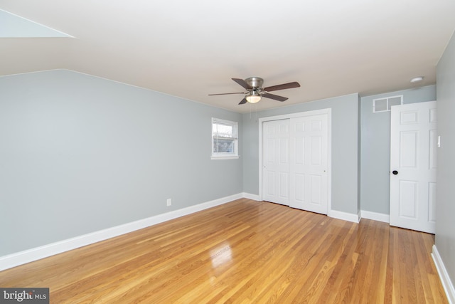 unfurnished bedroom with visible vents, baseboards, ceiling fan, light wood-style flooring, and a closet