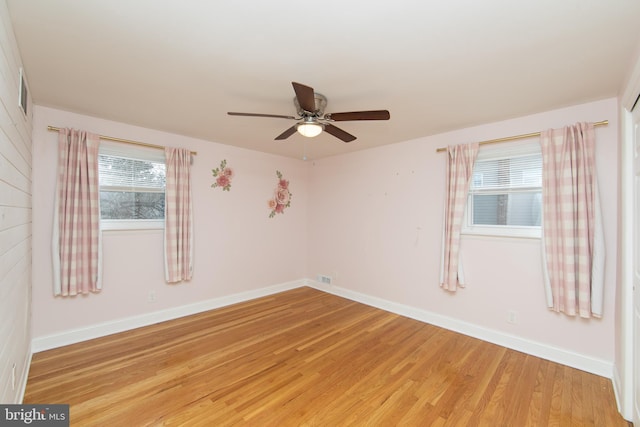 unfurnished room featuring visible vents, a ceiling fan, baseboards, and light wood finished floors