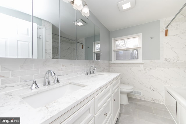 full bathroom with tile walls, toilet, visible vents, and a sink