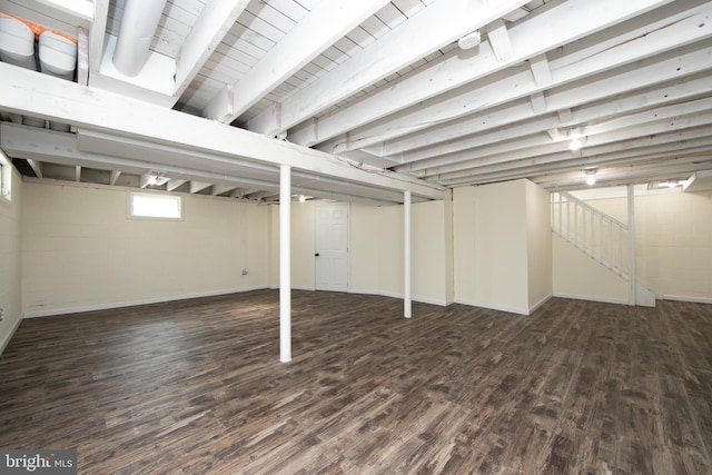 basement featuring wood finished floors and concrete block wall