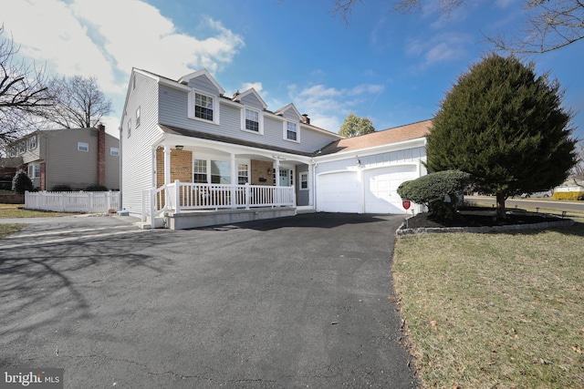 view of front of house featuring brick siding, fence, a porch, driveway, and an attached garage