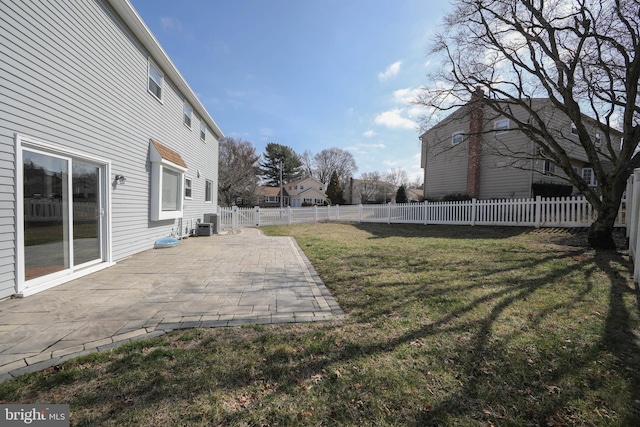 view of yard featuring cooling unit, a fenced backyard, and a patio area