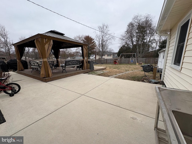 view of patio / terrace featuring a gazebo, fence, and a grill