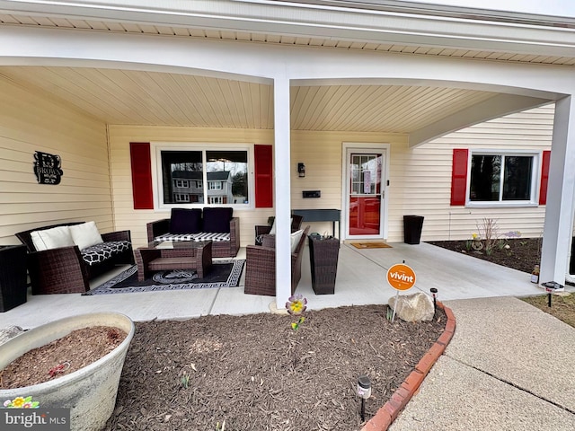 entrance to property with an outdoor hangout area and a patio