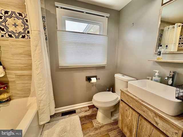 full bath with visible vents, toilet, a sink, shower / tub combo, and baseboards