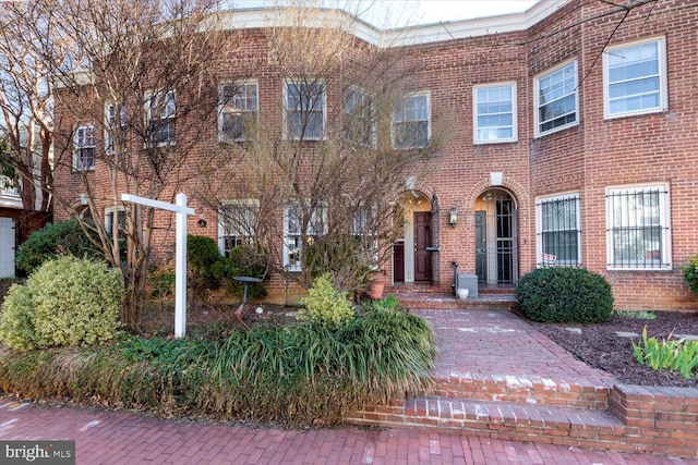 view of property with brick siding