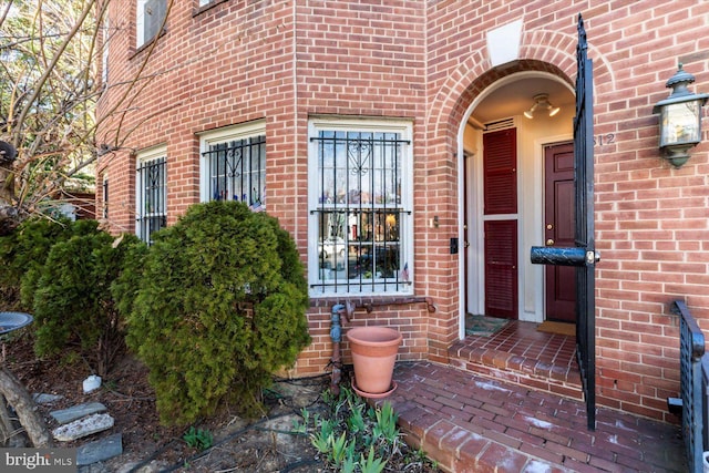 property entrance with brick siding