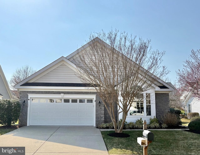 view of front of house featuring a front lawn, a garage, stone siding, and driveway