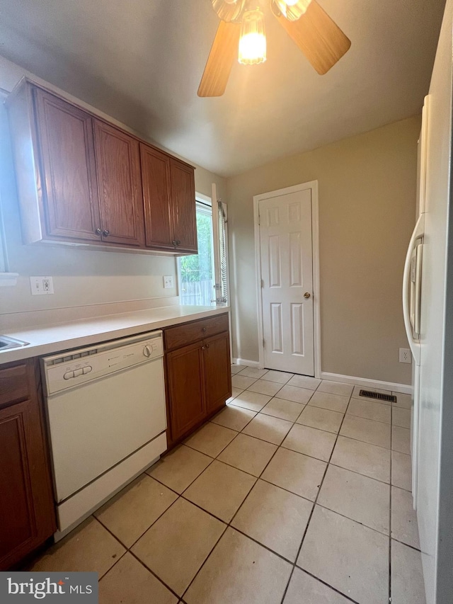 kitchen with visible vents, ceiling fan, light countertops, light tile patterned flooring, and white appliances