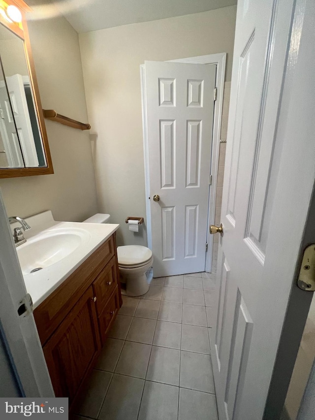 bathroom with tile patterned floors, toilet, and vanity