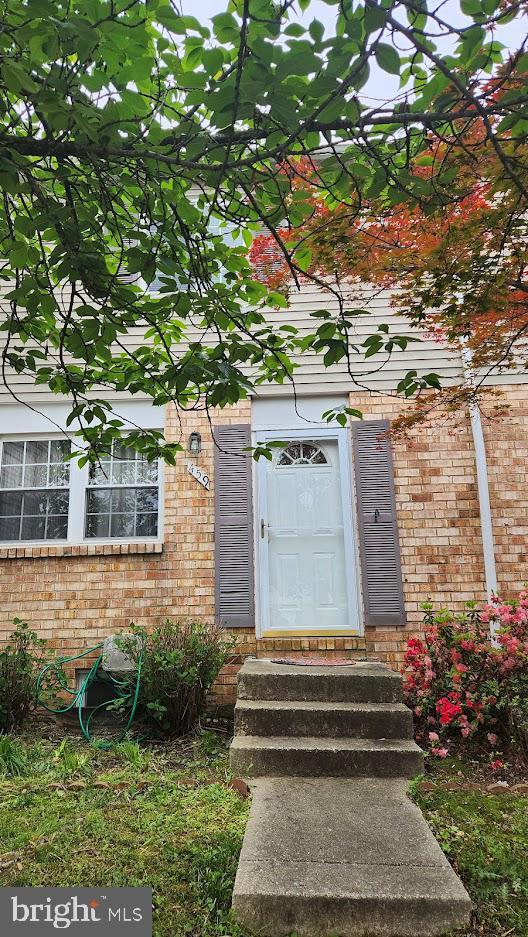 property entrance with brick siding