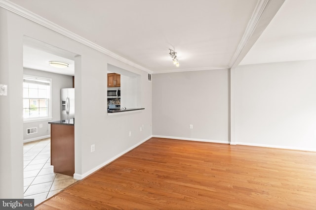 8042 Saint Annes Ct, Alexandria, VA 22309 - empty room with ornamental molding, baseboards, and light wood-style flooring