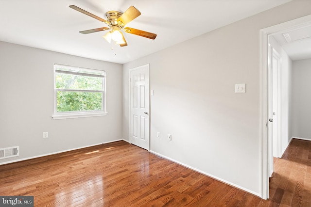 8042 Saint Annes Ct, Alexandria, VA 22309 - empty room with wood finished floors, baseboards, a ceiling fan, and attic access