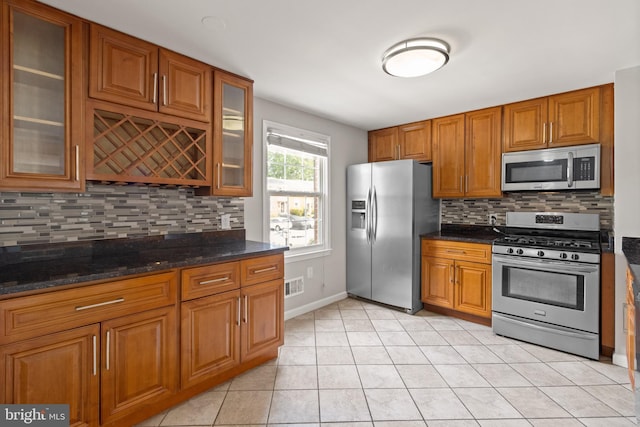8042 Saint Annes Ct, Alexandria, VA 22309 - kitchen with appliances with stainless steel finishes, brown cabinets, and decorative backsplash