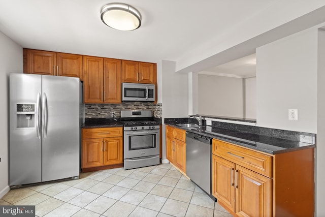 8042 Saint Annes Ct, Alexandria, VA 22309 - kitchen with appliances with stainless steel finishes, brown cabinets, a sink, backsplash, and dark stone counters