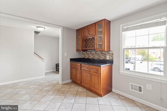 8042 Saint Annes Ct, Alexandria, VA 22309 - bar featuring light tile patterned floors, decorative backsplash, and baseboards