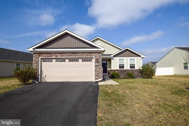 craftsman-style home featuring a front yard, stone siding, a garage, aphalt driveway, and board and batten siding