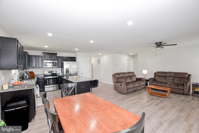 dining space featuring light wood finished floors, visible vents, baseboards, recessed lighting, and a ceiling fan