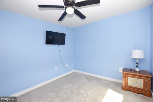 unfurnished bedroom with ceiling fan, carpet, and baseboards