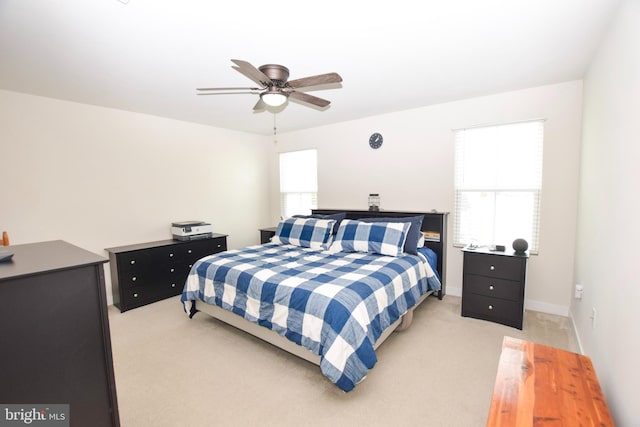 bedroom with multiple windows, light carpet, and ceiling fan