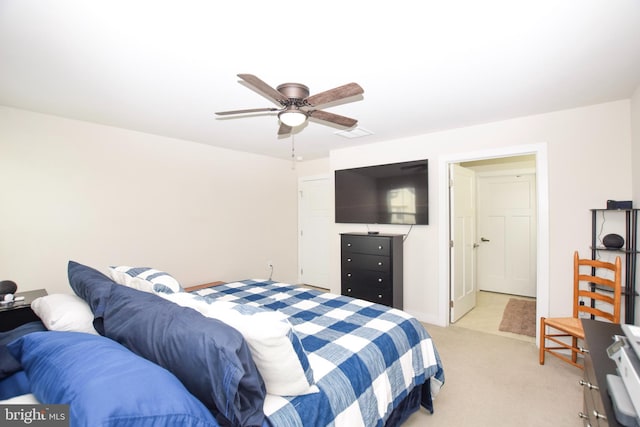 bedroom with light colored carpet and a ceiling fan