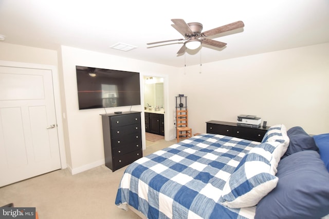 bedroom featuring visible vents, connected bathroom, baseboards, light colored carpet, and ceiling fan