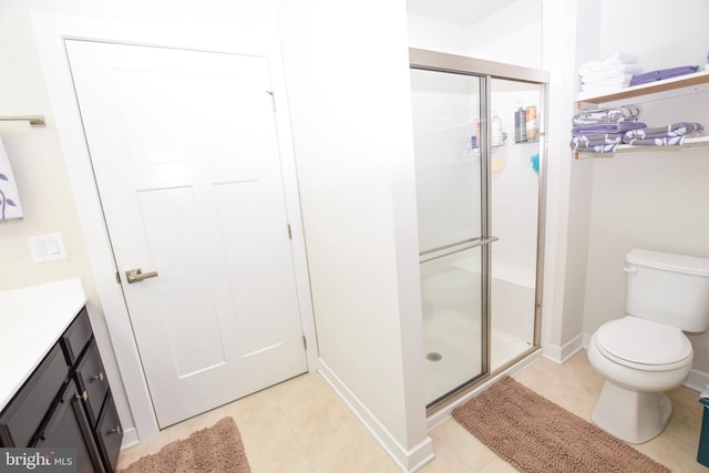 full bathroom featuring tile patterned floors, vanity, toilet, and a shower stall