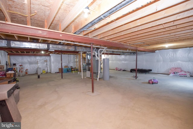 unfinished below grade area featuring heating unit and water heater