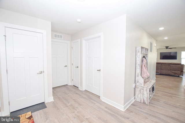 corridor with visible vents, recessed lighting, baseboards, and wood finished floors