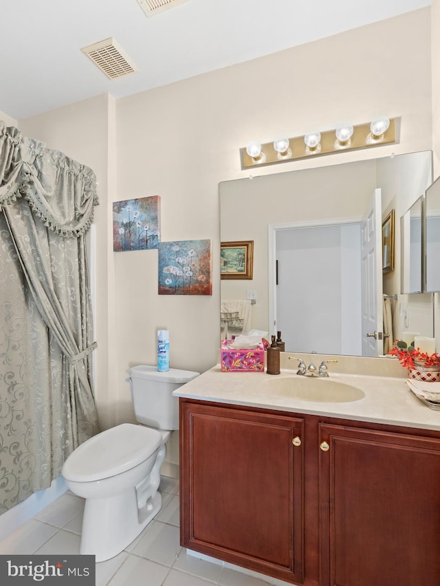 bathroom featuring tile patterned flooring, visible vents, toilet, and vanity