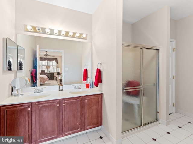 ensuite bathroom with ensuite bath, a ceiling fan, a shower stall, and a sink