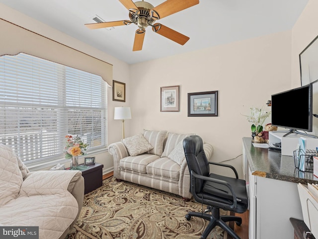 home office with baseboards and ceiling fan