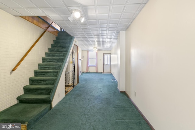 interior space with baseboards and carpet floors