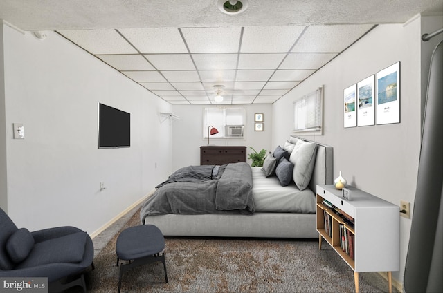 bedroom featuring carpet flooring and a paneled ceiling