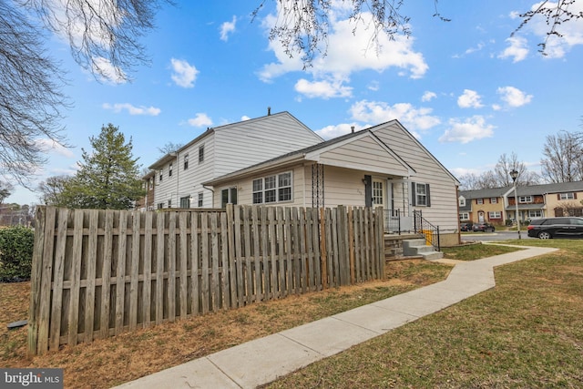 bungalow featuring a fenced front yard and a front yard