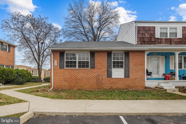 view of front of house with brick siding and a porch