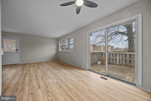 unfurnished living room with visible vents, wood finished floors, and ceiling fan