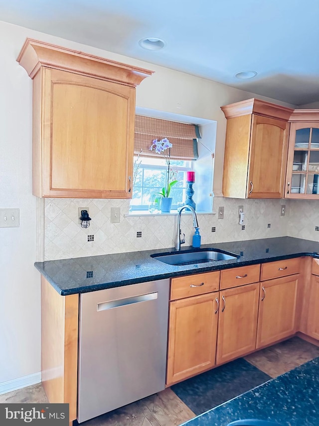 kitchen with a sink, glass insert cabinets, tasteful backsplash, and dishwasher