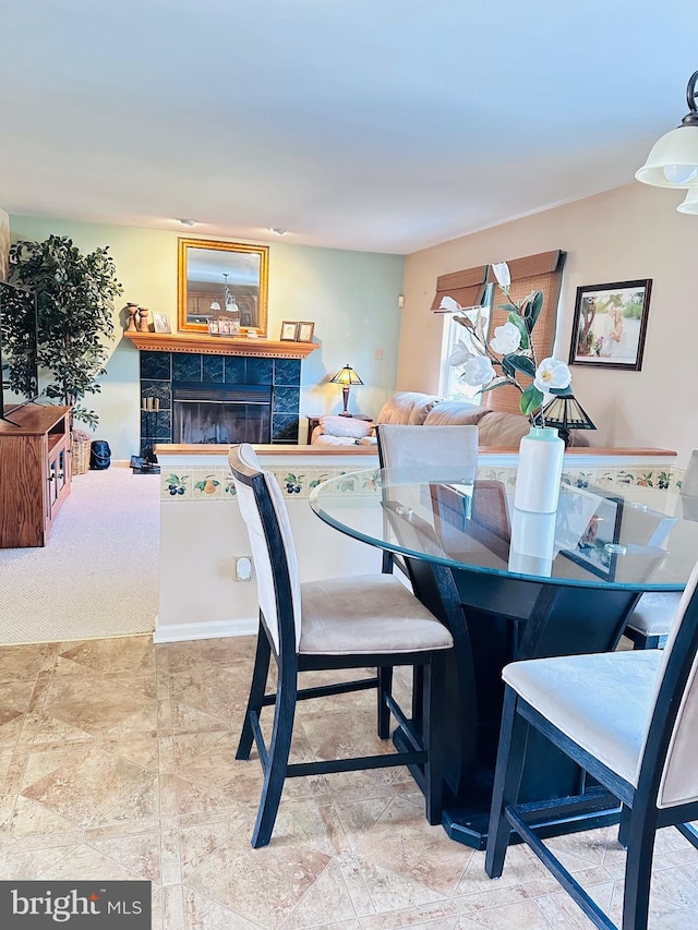 dining room with a tiled fireplace